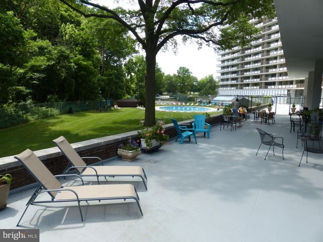 a view of a patio with a table chairs and a fire pit