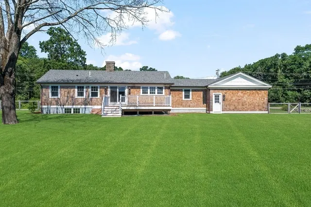 a kitchen with granite countertop a sink stove and cabinets