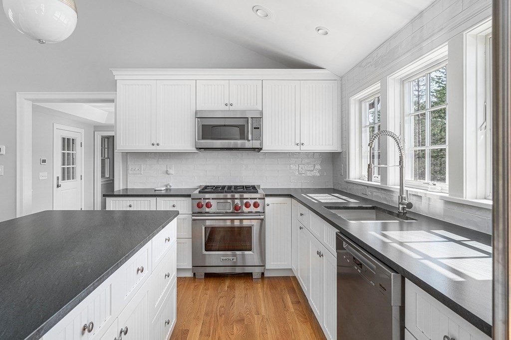 23 Bay State Road Rehoboth, MA 02769 - Photo 20 of 42 a kitchen with granite countertop a sink stove and cabinets