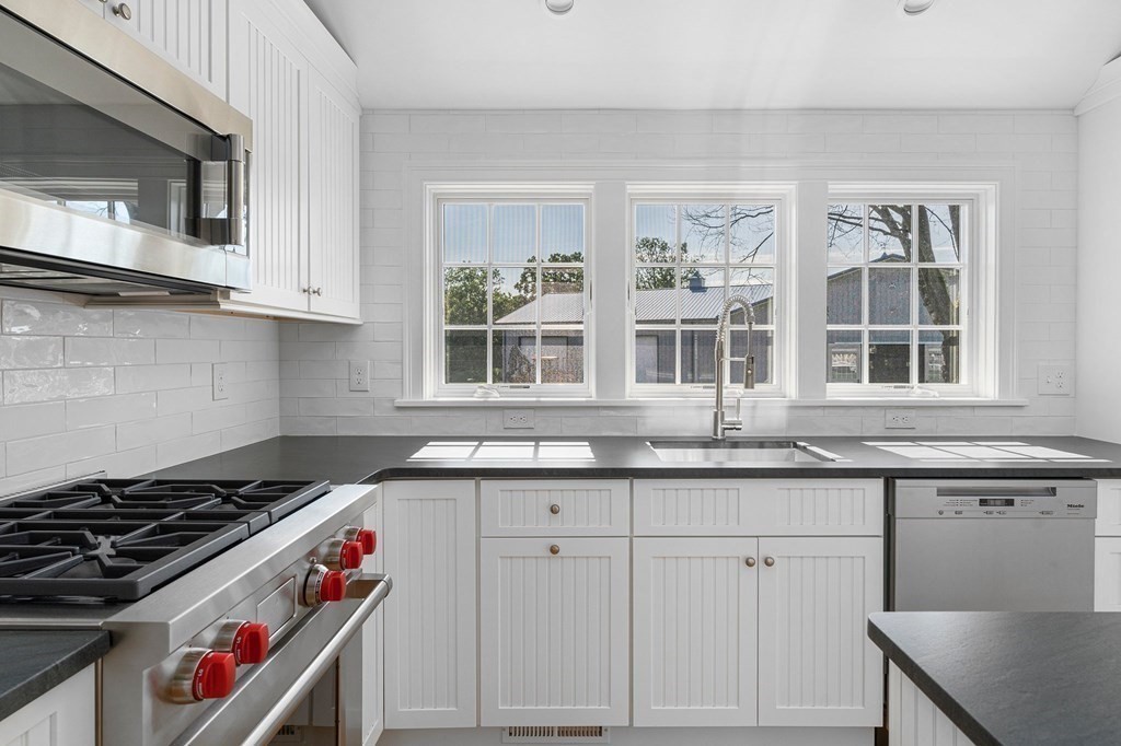 23 Bay State Road Rehoboth, MA 02769 - Photo 22 of 42 a kitchen with granite countertop a stove and a sink