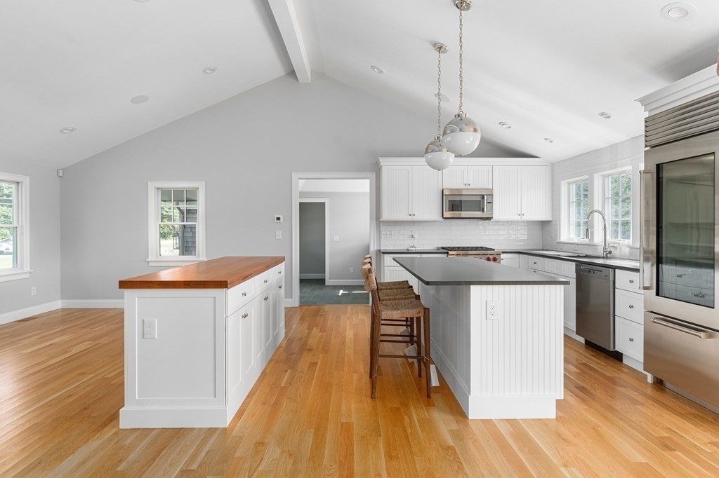 23 Bay State Road Rehoboth, MA 02769 - Photo 23 of 42 a kitchen with stainless steel appliances granite countertop a sink a stove a refrigerator cabinets and wooden floor