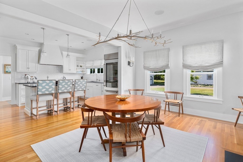 23 Bay State Road Rehoboth, MA 02769 - Photo 32 of 42 a dining room with wooden floor a chandelier a wooden table and chairs