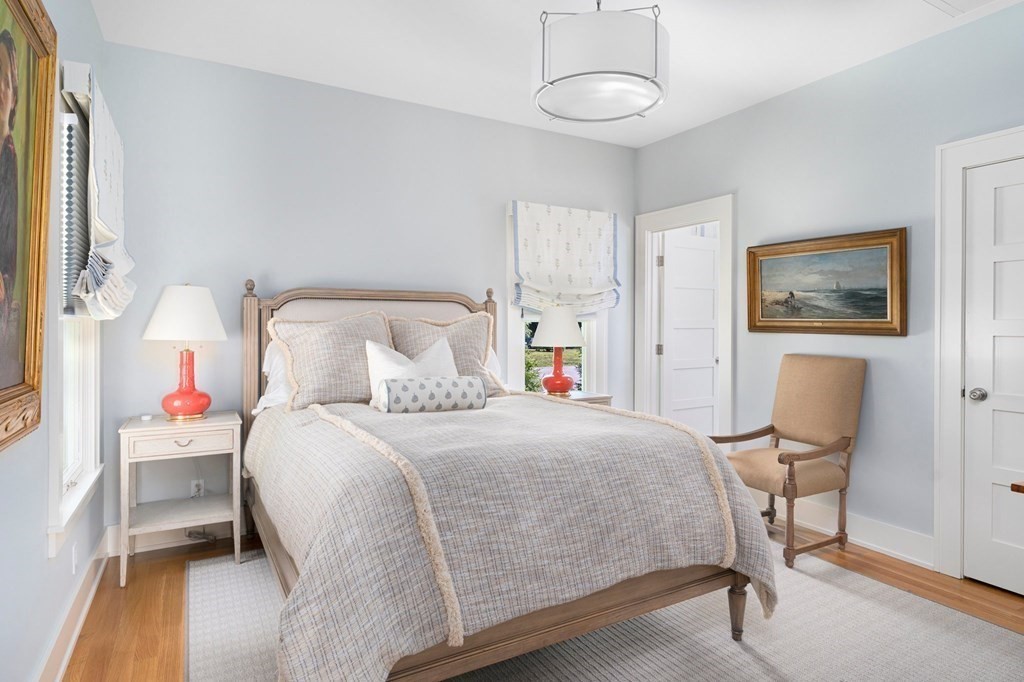 23 Bay State Road Rehoboth, MA 02769 - Photo 33 of 42 a bedroom with a bed and a chandelier