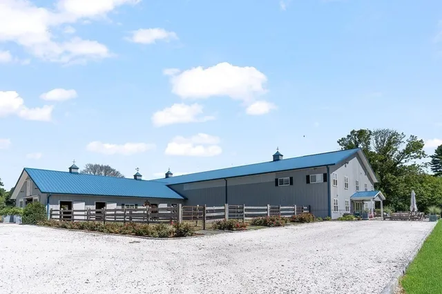 a front view of a house with a yard covered in snow