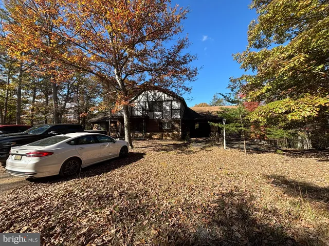 a street view with couple of cars parked on road