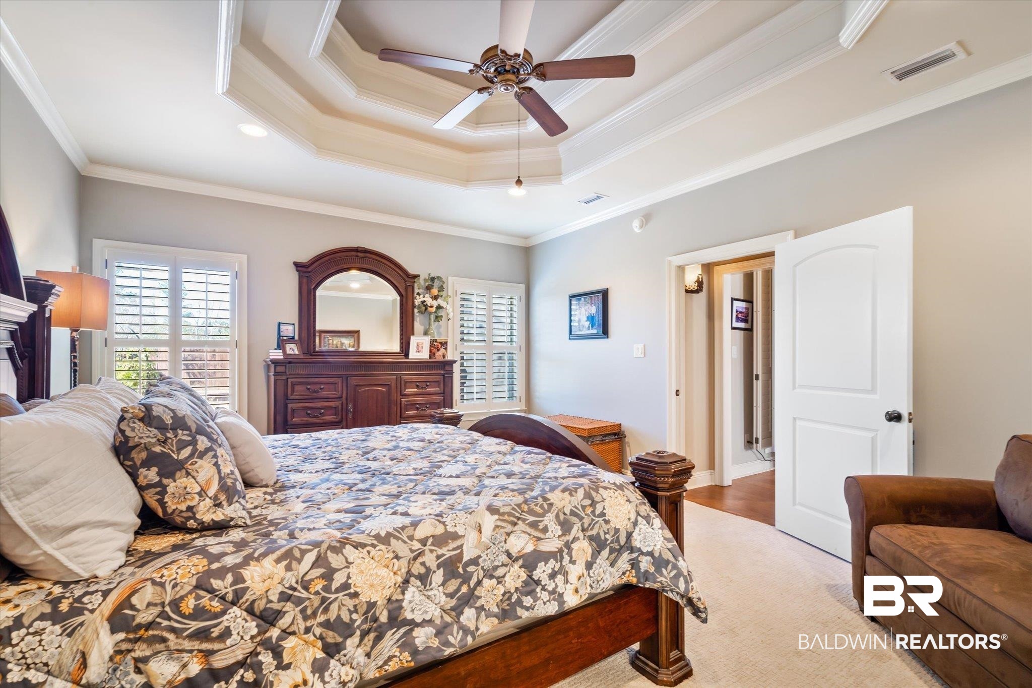 5683 Spring Landing Drive Theodore, AL 36582 - Photo 17 of 49 Bedroom featuring light hardwood / wood-style flooring, a tray ceiling, ceiling fan, and ornamental molding