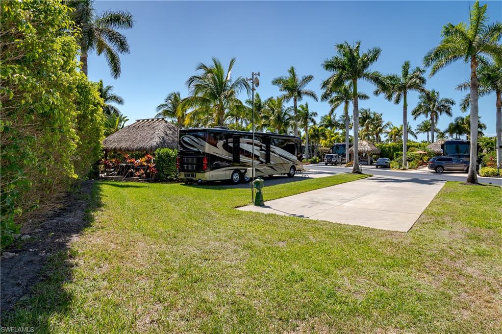 13594 Snapper Lane Naples, FL 34114 - Photo 16 of 29 a swimming pool with trees in the background