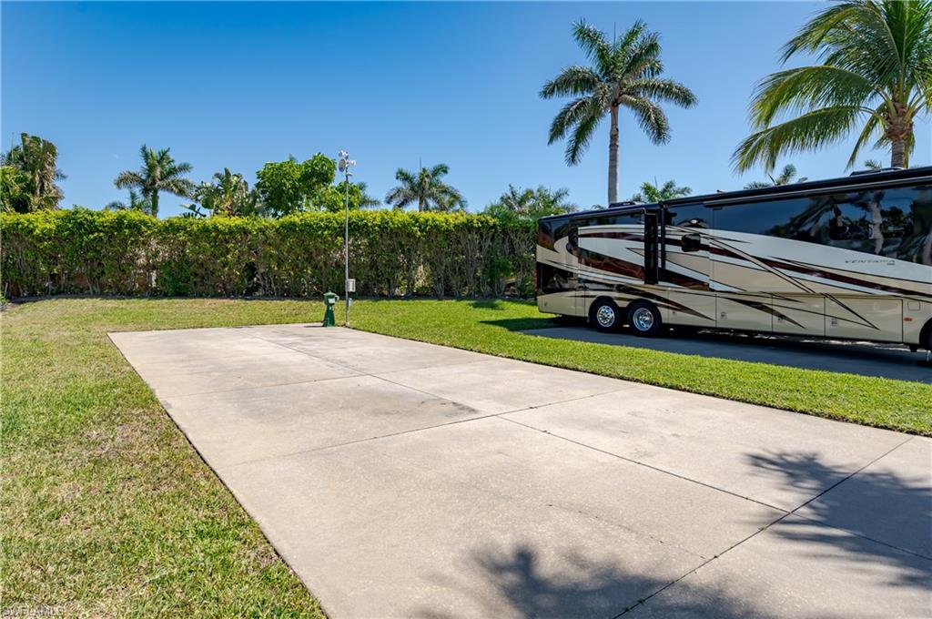 13594 Snapper Lane Naples, FL 34114 - Photo 19 of 29 a view of a backyard with a garden