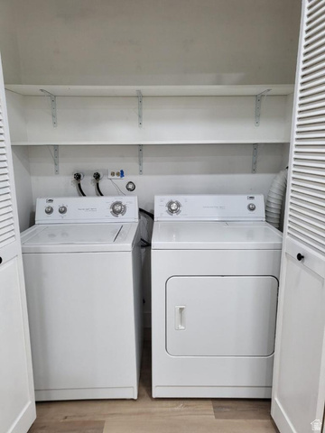 6884 670 East Midvale, UT 84047 - Photo 19 of 28 Laundry area with washing machine and dryer and light wood finished floors