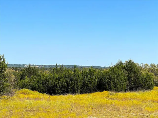 a view of backyard with swimming pool and outdoor seating