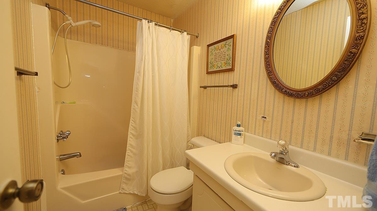 639 Pine Ridge Place, Unit 639 Raleigh, NC 27609 - Photo 14 of 14 a bathroom with a sink a toilet and shower