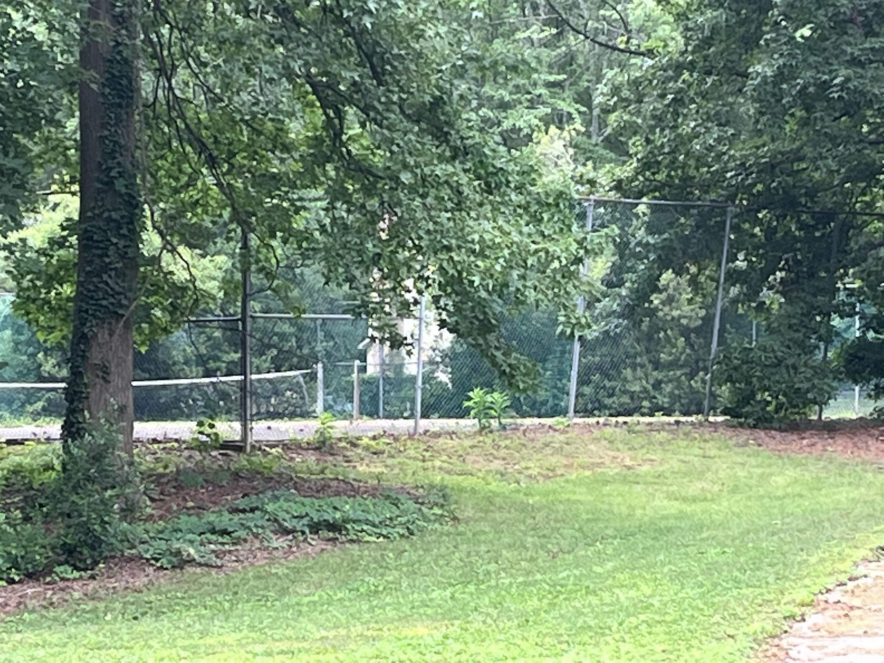 639 Pine Ridge Place, Unit 639 Raleigh, NC 27609 - Photo 3 of 14 a backyard of a house with lots of trees