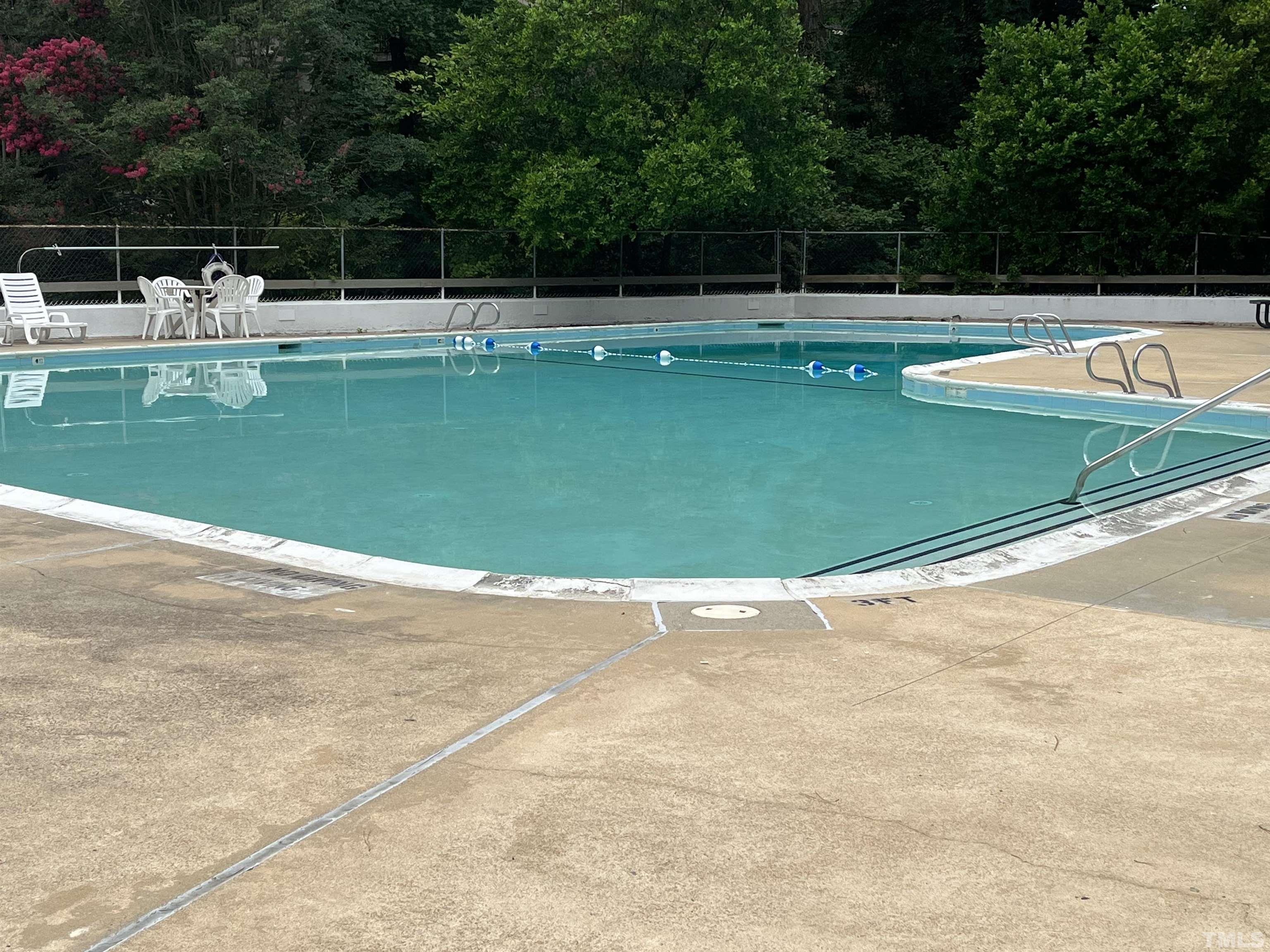 639 Pine Ridge Place, Unit 639 Raleigh, NC 27609 - Photo 4 of 14 a view of a swimming pool with a yard
