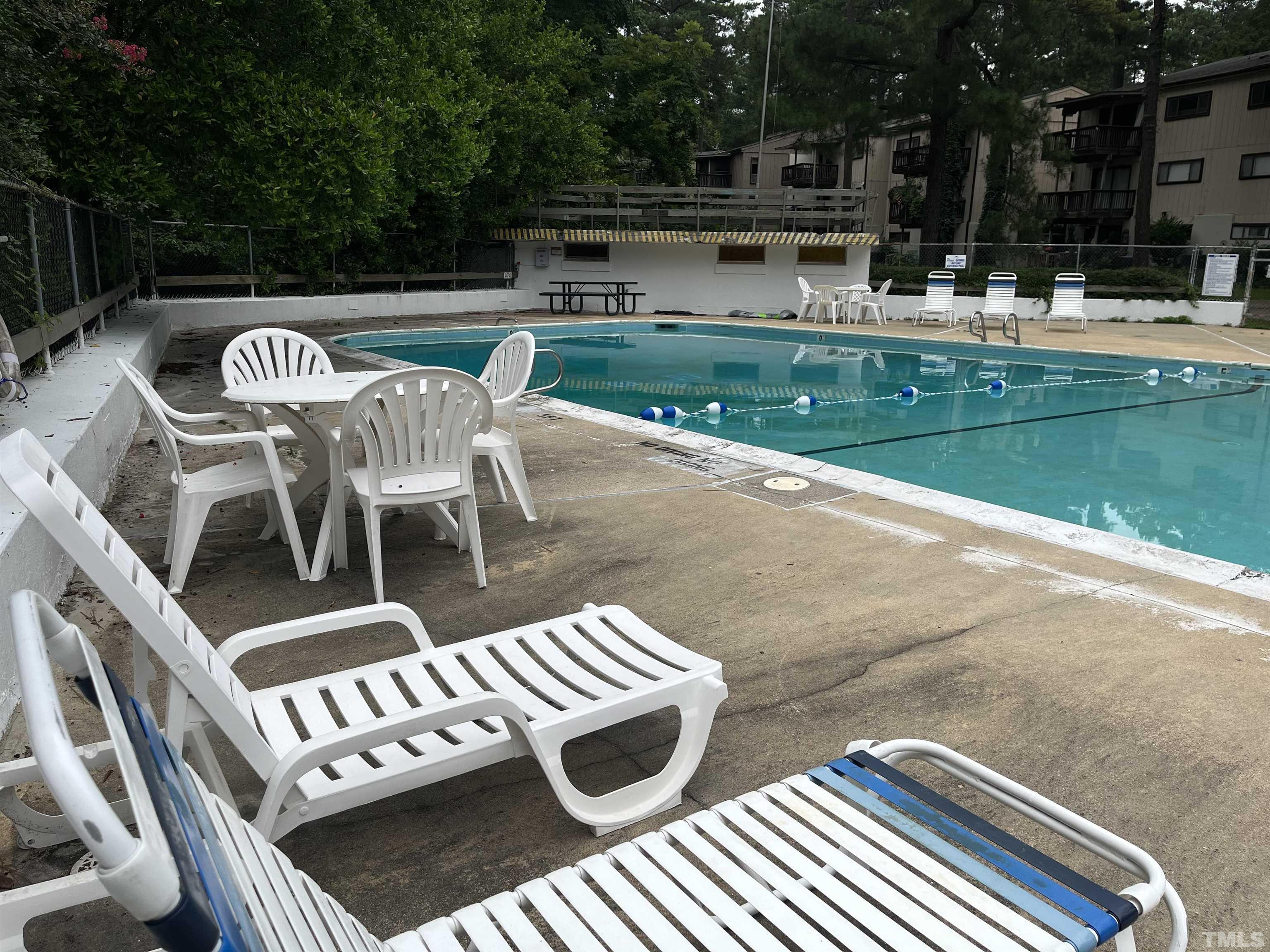 639 Pine Ridge Place, Unit 639 Raleigh, NC 27609 - Photo 5 of 14 a view of a patio with table and chairs with wooden floor and fence