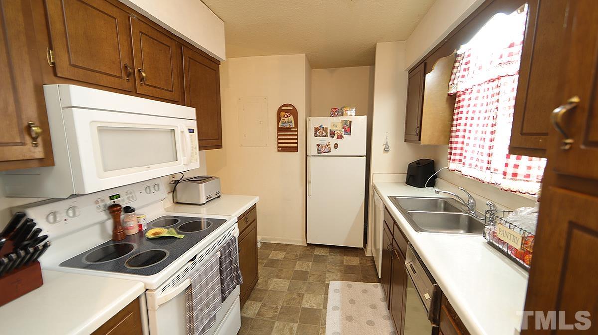 639 Pine Ridge Place, Unit 639 Raleigh, NC 27609 - Photo 7 of 14 a kitchen with a sink stove and cabinets