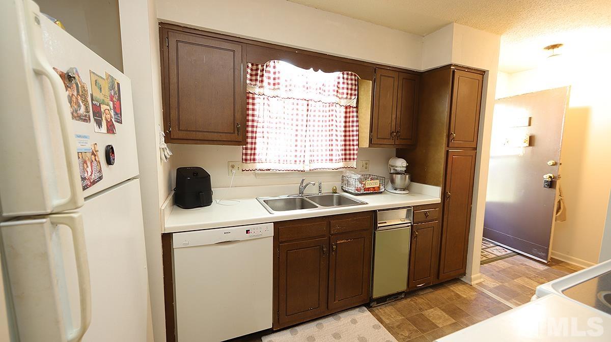639 Pine Ridge Place, Unit 639 Raleigh, NC 27609 - Photo 8 of 14 a utility room with cabinets dryer and washer