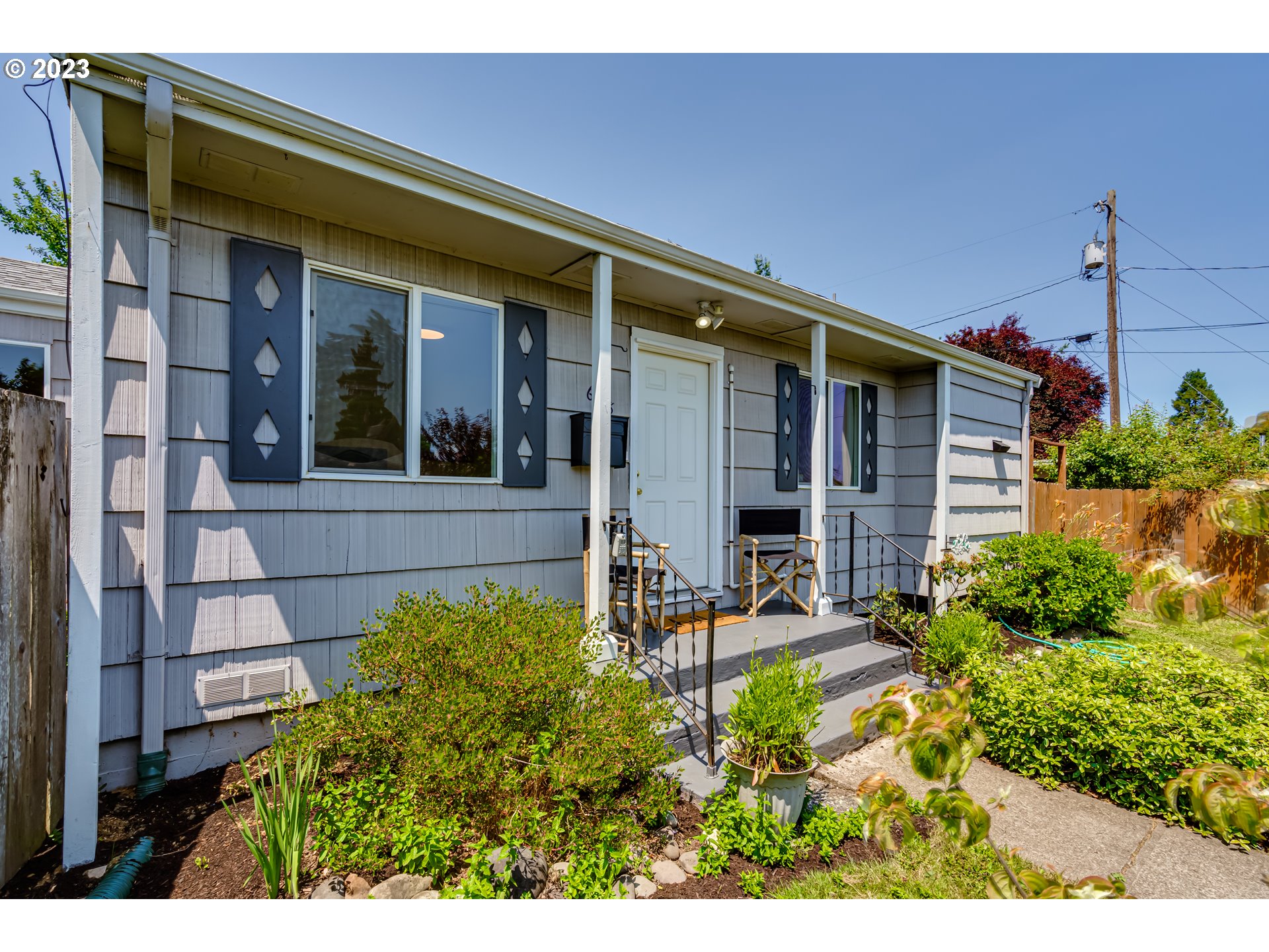 618 19th Street Springfield, OR 97477 - Photo 2 of 6 a view of a house with potted plants and a bench