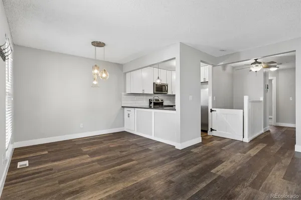 a view of a kitchen with a dishwasher cabinets and wooden floor