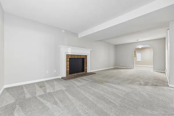 an empty room with a fireplace