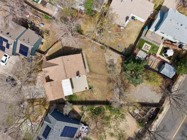 an aerial view of a house with a yard