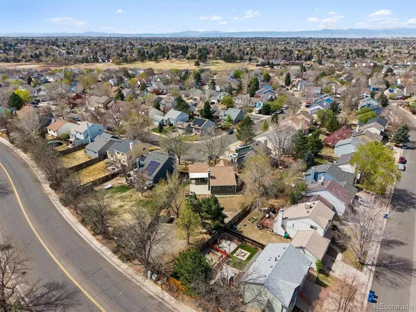 an aerial view of a residential houses with outdoor space