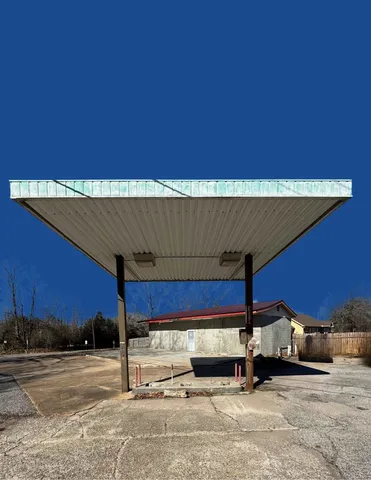 a view of a big building with swimming pool in front of it