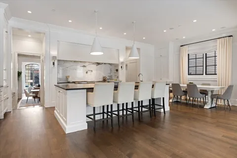 a dining room with furniture and wooden floor