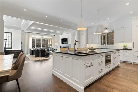 a kitchen with stainless steel appliances a stove and a large window