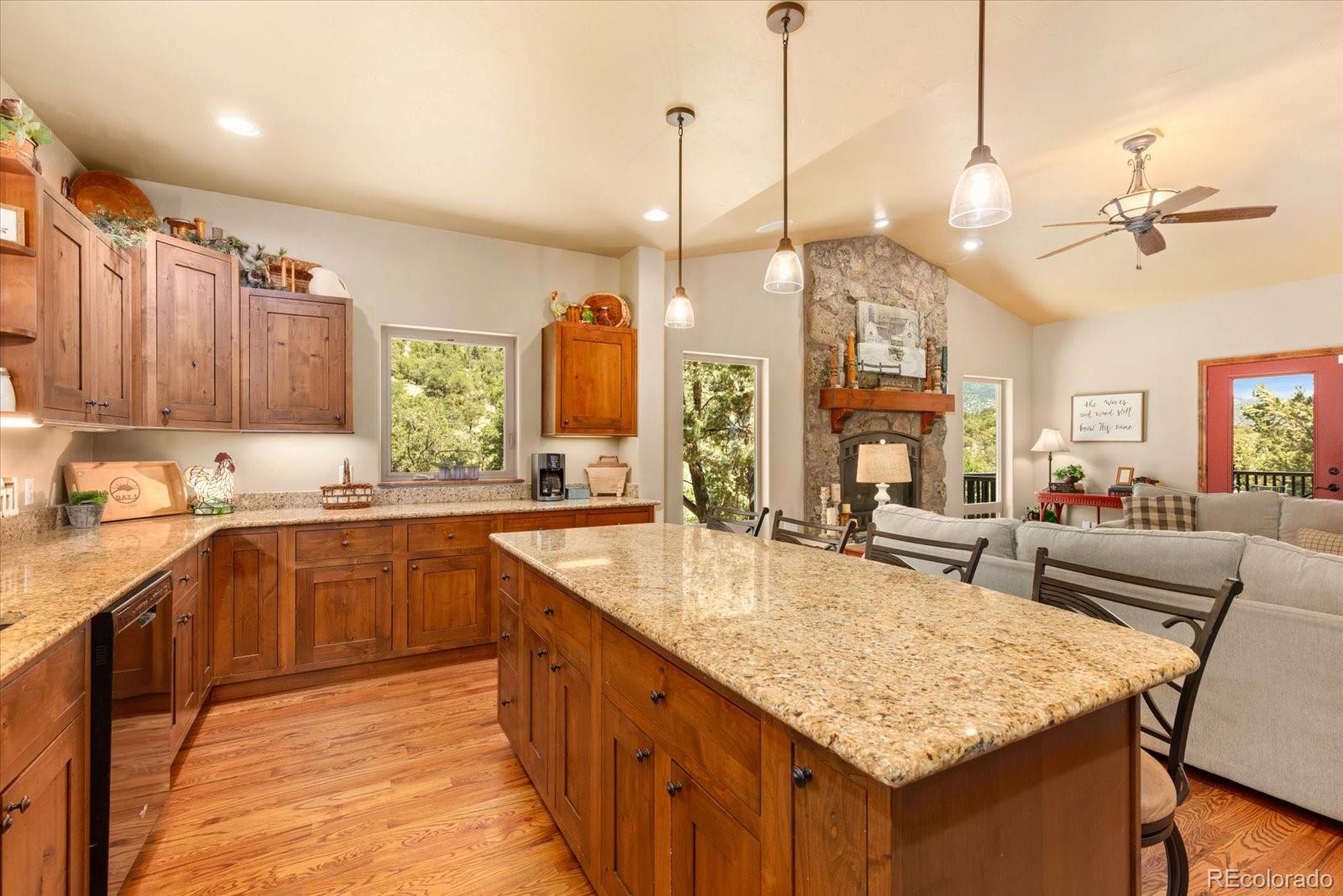 990 Hamilton Creek Road Coaldale, CO 81222 - Photo 12 of 49 a kitchen with kitchen island granite countertop a sink counter top space and living room view