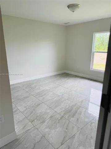 a bathroom with a granite countertop bathtub sink vanity mirror and toilet
