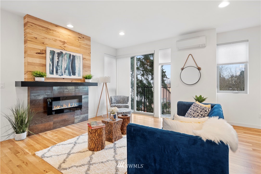 3932 South Brandon Street, Unit B Seattle, WA 98118 - Photo 12 of 29 a bedroom with a large bed and a fireplace