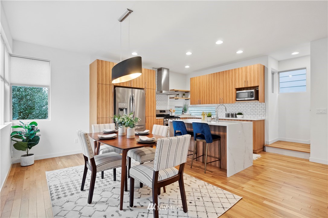 3932 South Brandon Street, Unit B Seattle, WA 98118 - Photo 14 of 29 a view of a dining room with furniture and a kitchen