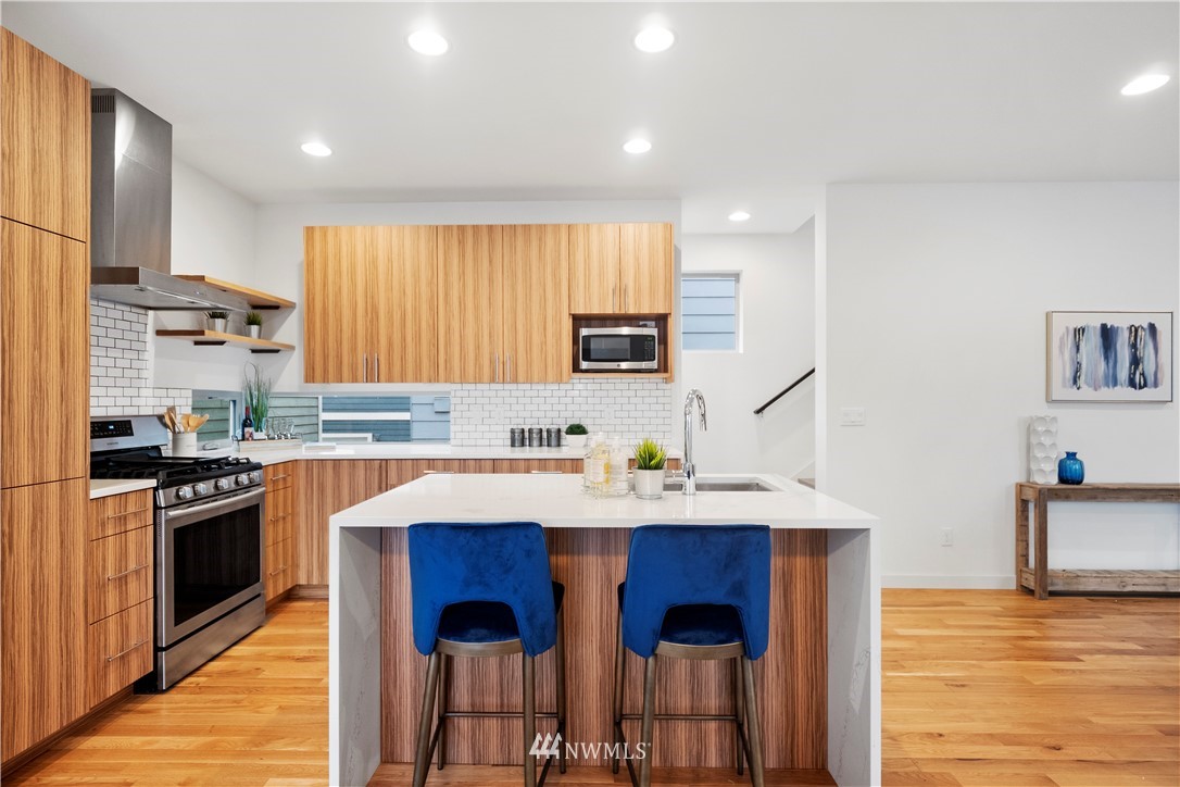 3932 South Brandon Street, Unit B Seattle, WA 98118 - Photo 18 of 29 a kitchen with stainless steel appliances granite countertop a sink stove and refrigerator