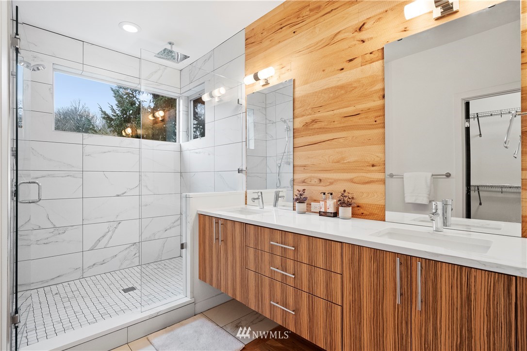 3932 South Brandon Street, Unit B Seattle, WA 98118 - Photo 23 of 29 a bathroom with a double vanity sink mirror and shower