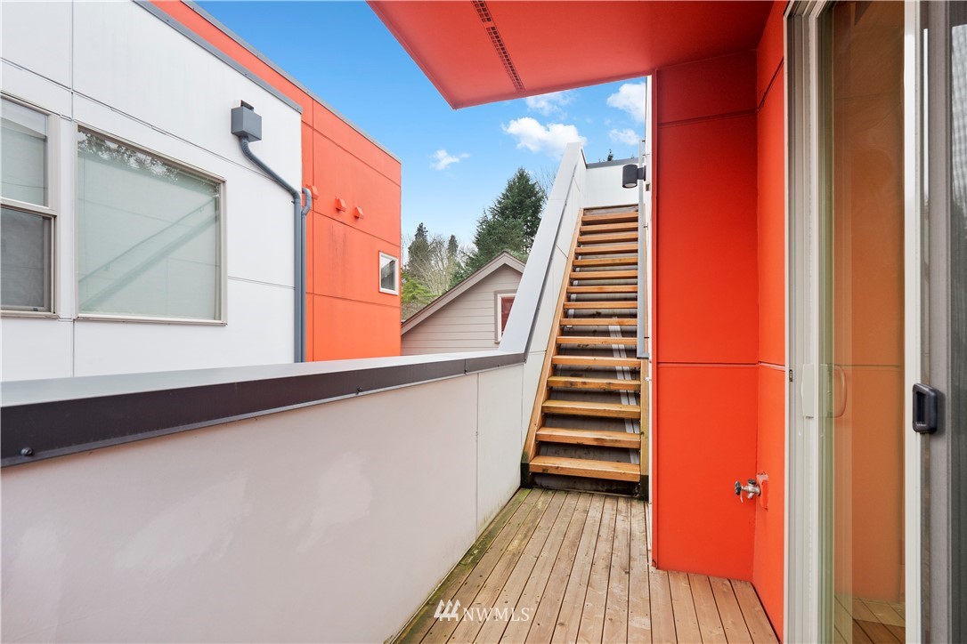3932 South Brandon Street, Unit B Seattle, WA 98118 - Photo 26 of 29 a view of a balcony with wooden floor and stairs