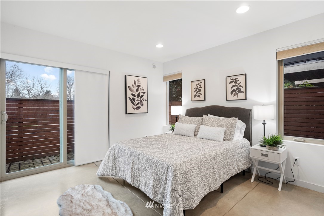 3932 South Brandon Street, Unit B Seattle, WA 98118 - Photo 5 of 29 a bedroom with a large bed and a chair