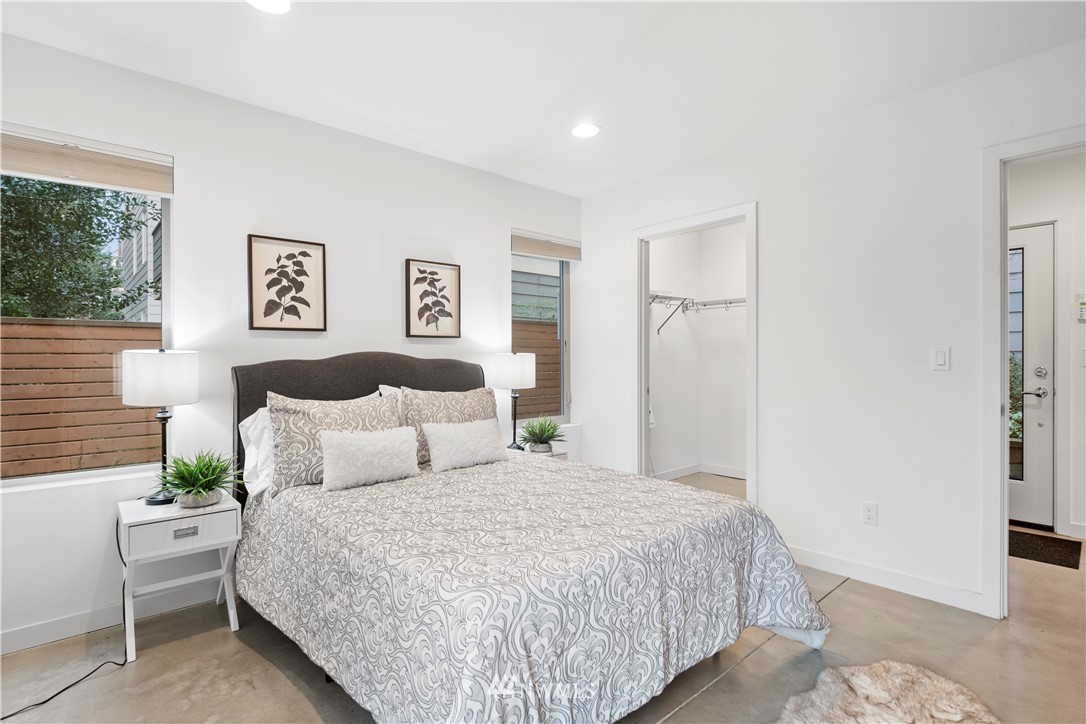 3932 South Brandon Street, Unit B Seattle, WA 98118 - Photo 6 of 29 a bedroom with a large bed and a couch