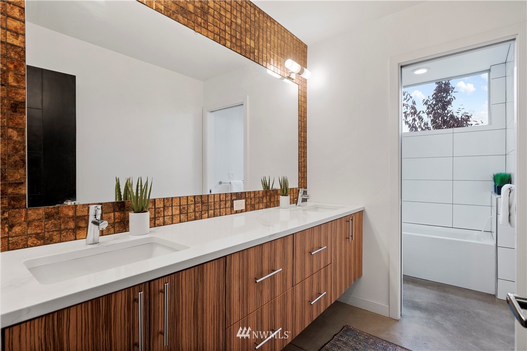 3932 South Brandon Street, Unit B Seattle, WA 98118 - Photo 7 of 29 a bathroom with a double vanity sink and a mirror