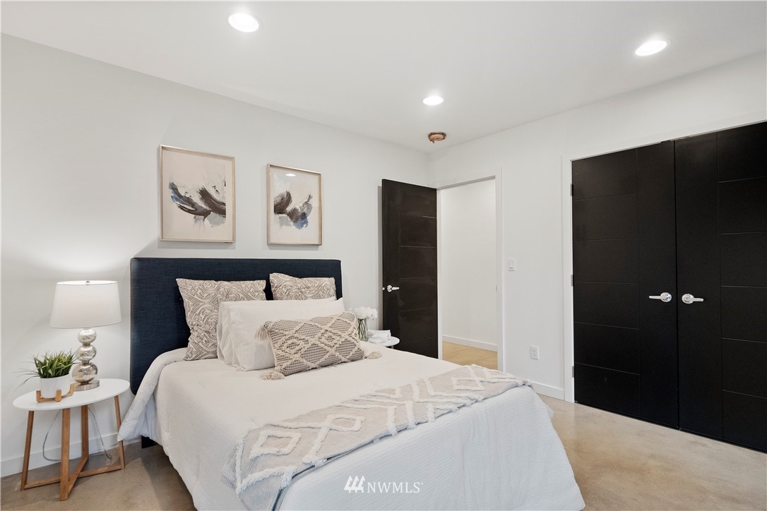 3932 South Brandon Street, Unit B Seattle, WA 98118 - Photo 9 of 29 a bedroom with a bed and painting on the wall