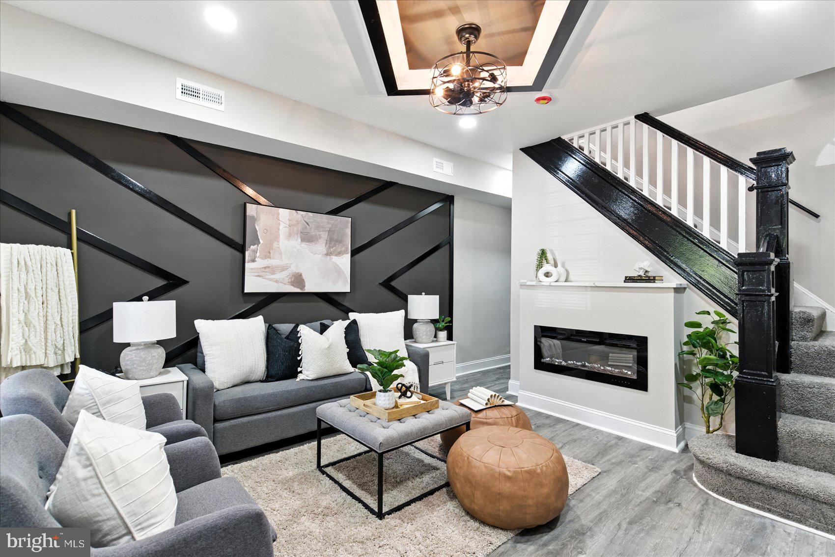 1607 Montpelier Street Baltimore, MD 21218 - Photo 1 of 37 a living room with furniture and a fireplace