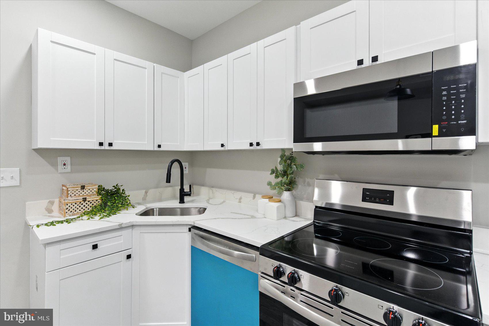 1607 Montpelier Street Baltimore, MD 21218 - Photo 13 of 37 a kitchen with appliances and cabinets