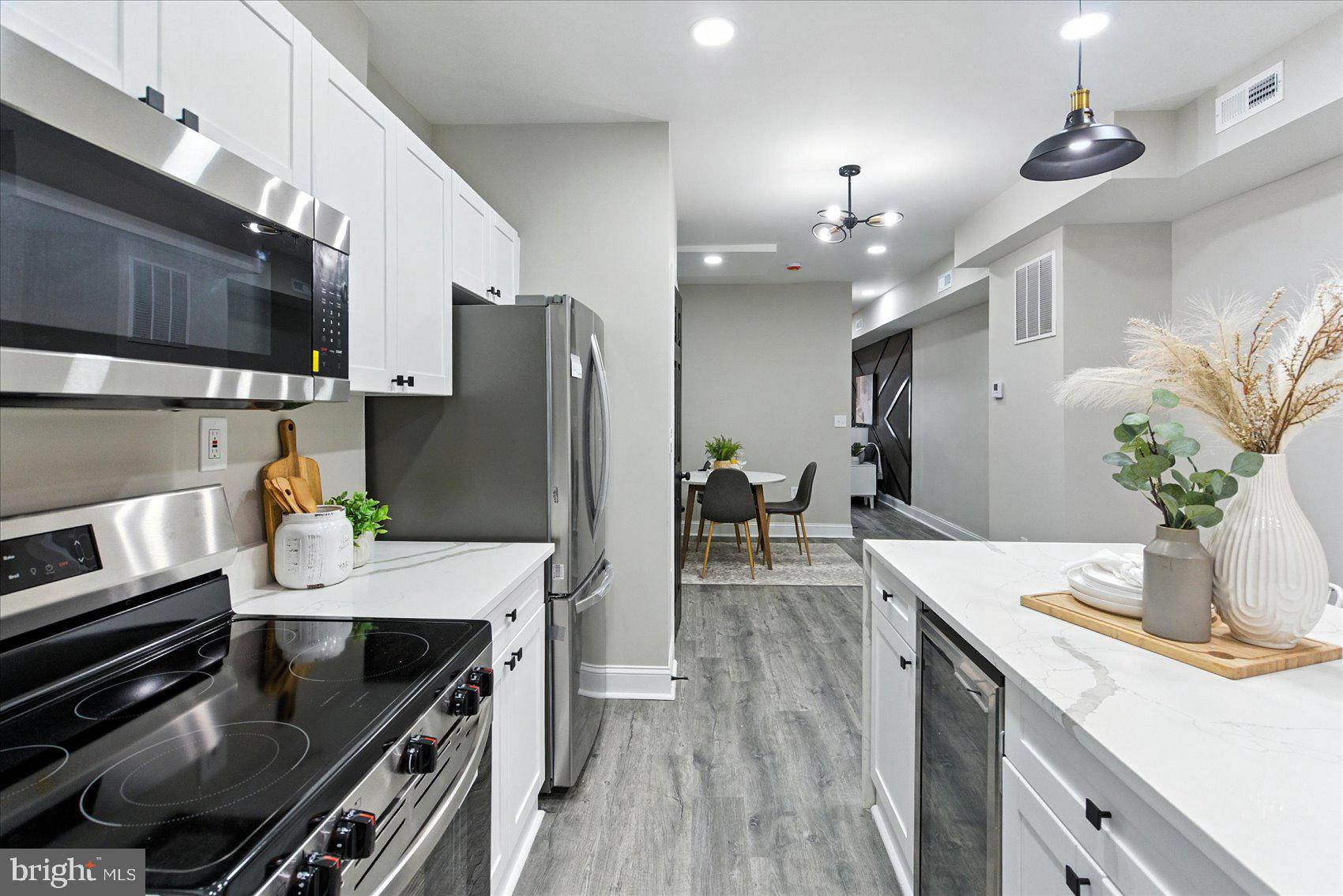 1607 Montpelier Street Baltimore, MD 21218 - Photo 14 of 37 a kitchen with a refrigerator and a stove