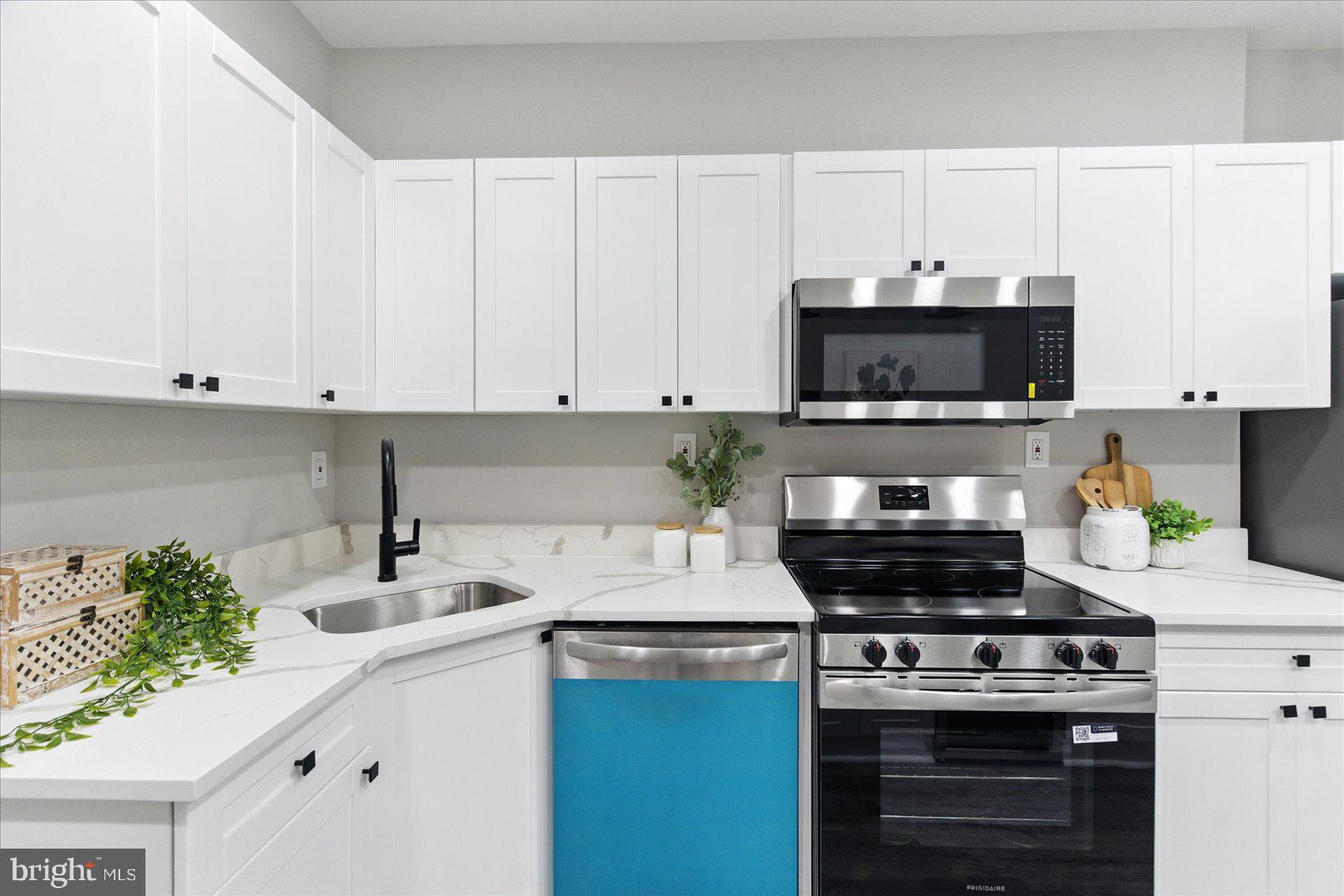 1607 Montpelier Street Baltimore, MD 21218 - Photo 17 of 37 a kitchen with appliances a sink and a counter top space