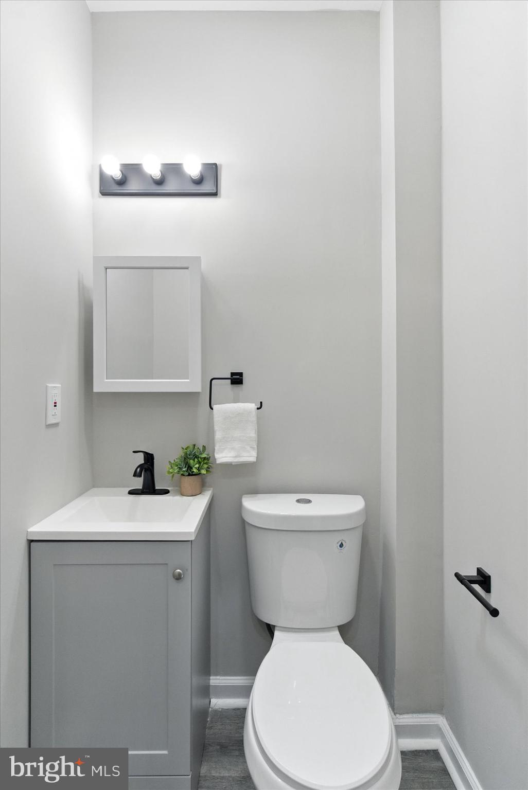 1607 Montpelier Street Baltimore, MD 21218 - Photo 18 of 37 a bathroom with a toilet sink and mirror