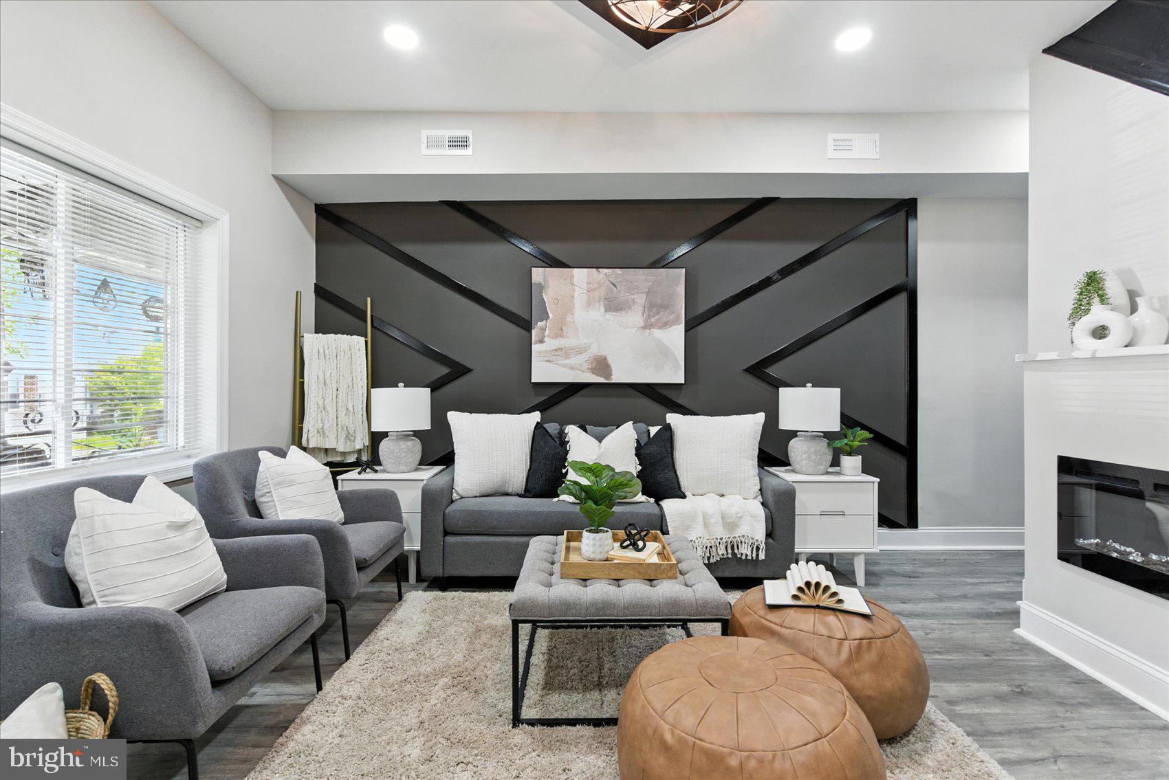 1607 Montpelier Street Baltimore, MD 21218 - Photo 2 of 37 a living room with furniture and a fireplace