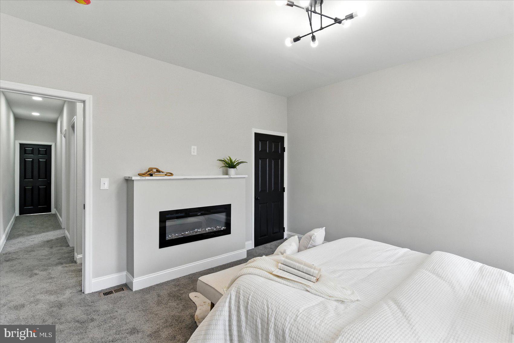 1607 Montpelier Street Baltimore, MD 21218 - Photo 25 of 37 a bedroom with a bed and a fireplace