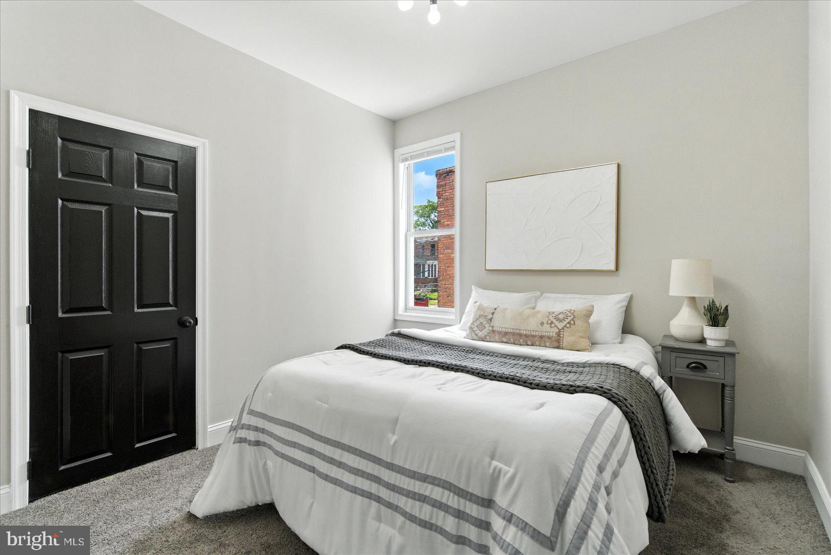 1607 Montpelier Street Baltimore, MD 21218 - Photo 27 of 37 a bedroom with a bed and cabinets