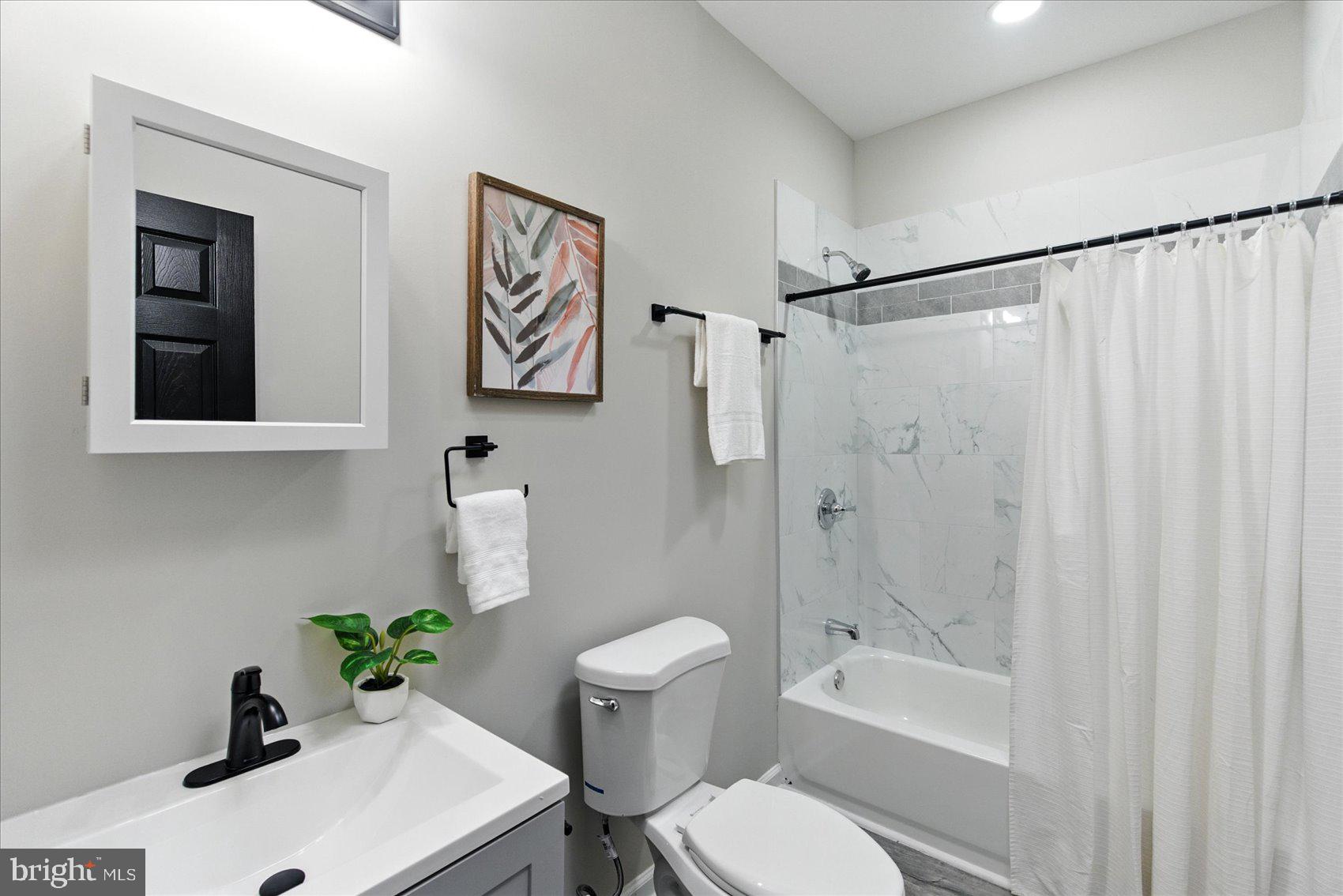1607 Montpelier Street Baltimore, MD 21218 - Photo 32 of 37 a bathroom with a sink toilet and shower