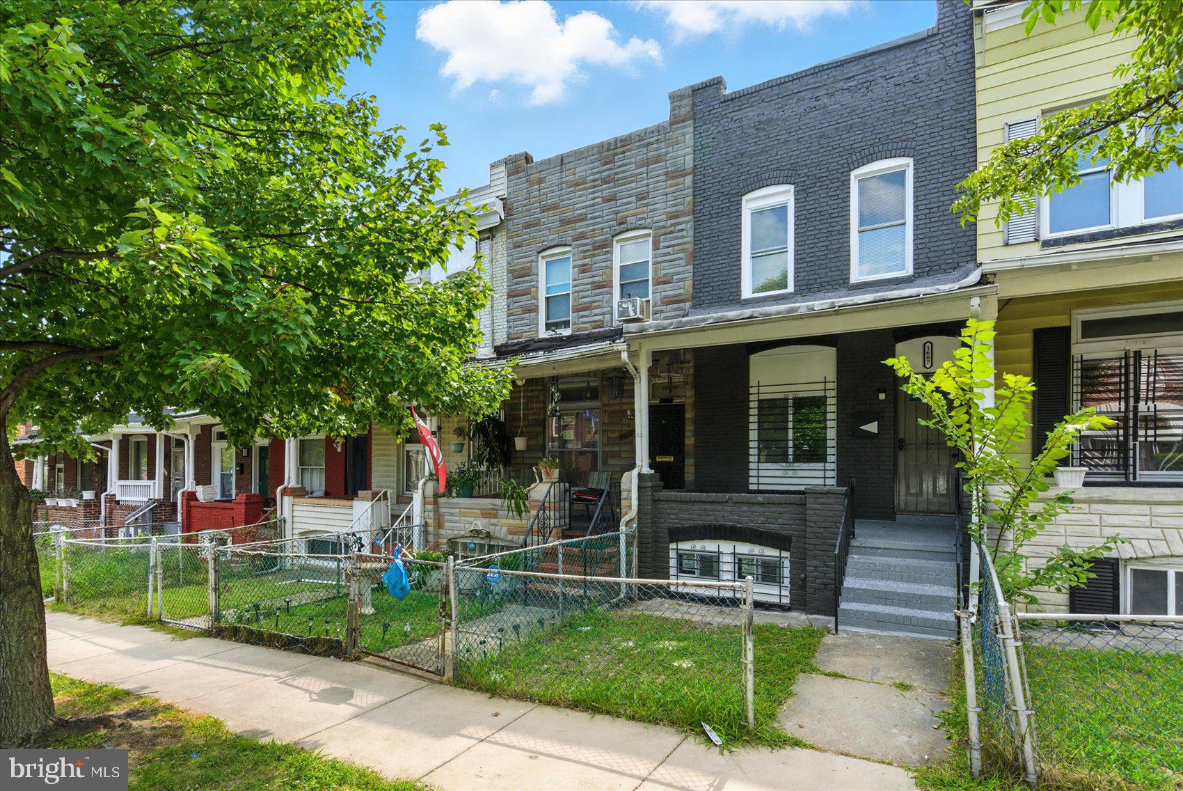 1607 Montpelier Street Baltimore, MD 21218 - Photo 34 of 37 a front view of a house with a yard