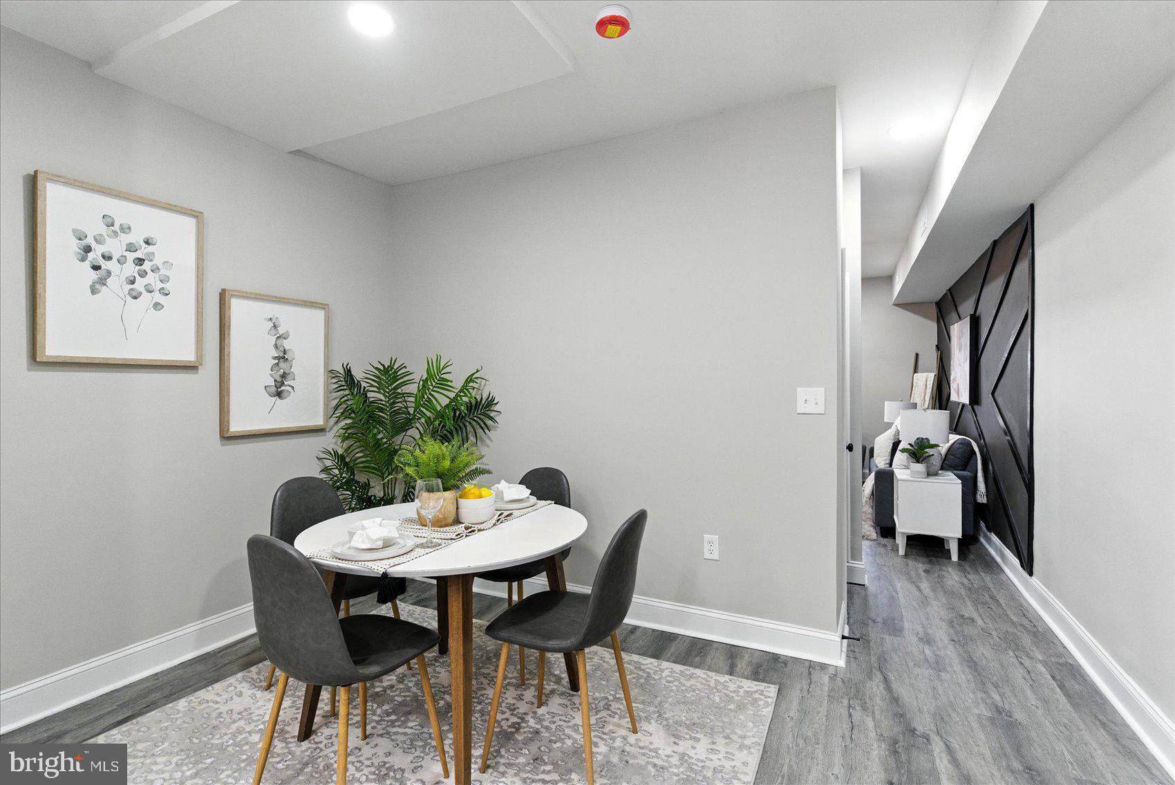 1607 Montpelier Street Baltimore, MD 21218 - Photo 7 of 37 a dining room with furniture and wooden floor